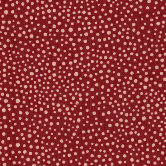 Tissu en coton rouge à petits pois blancs classiques, un indispensable pour toutes vos créations couture, disponible chez Mille et Un Tissus à Moulins.